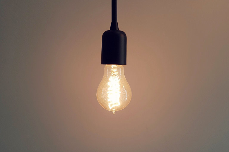 Hanging lightbulb symbolising insight and clarity through counselling”